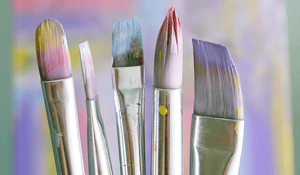paintbrushes with purple blue paint